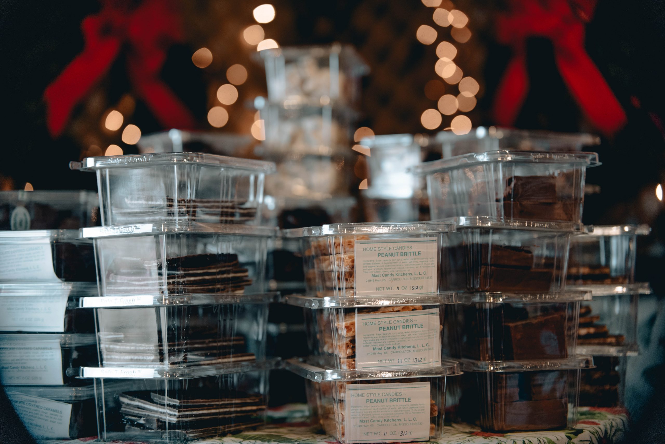 Stacks of boxed candies under holiday lights