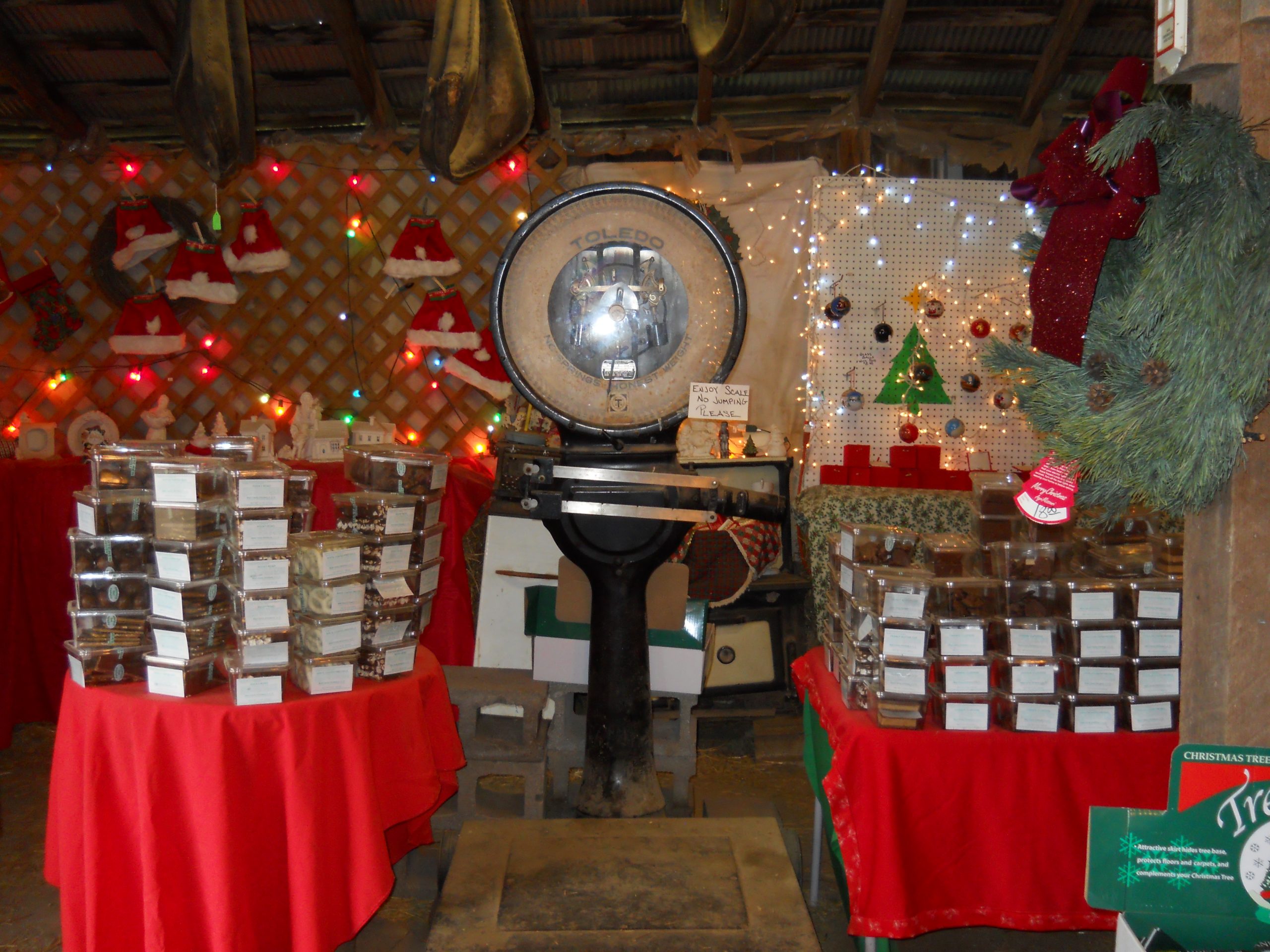 Inside the barn: candy boxes on red tables beneath the old scale